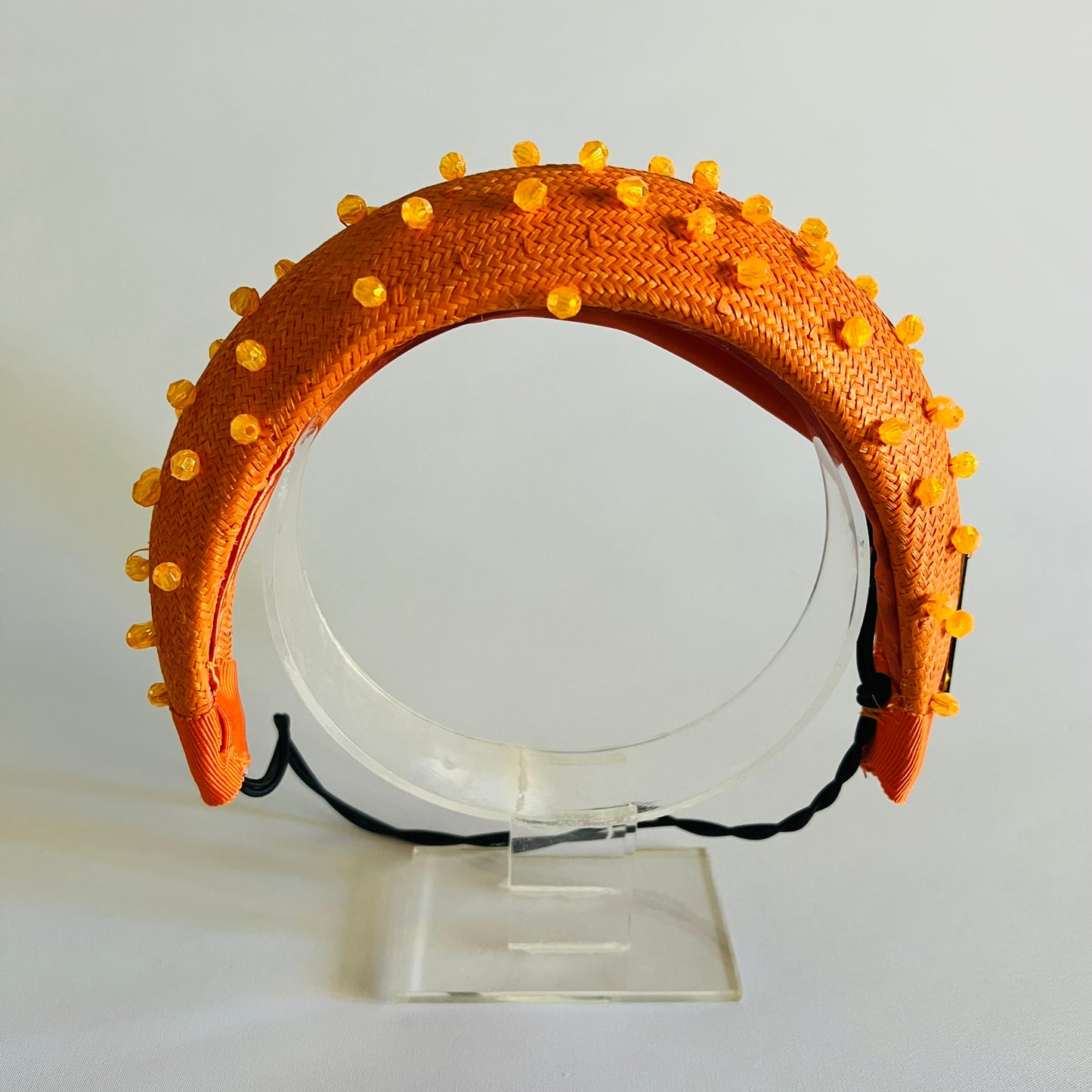 Orange padded headband finished with delicate bead trim