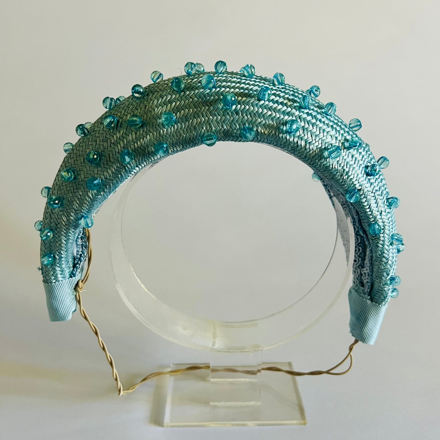 A pale blue padded headband finished with delicate bead trim. Stylish yet comfortable, it’s an easy way to elevate your look. Secured with elastic to the back of the head.