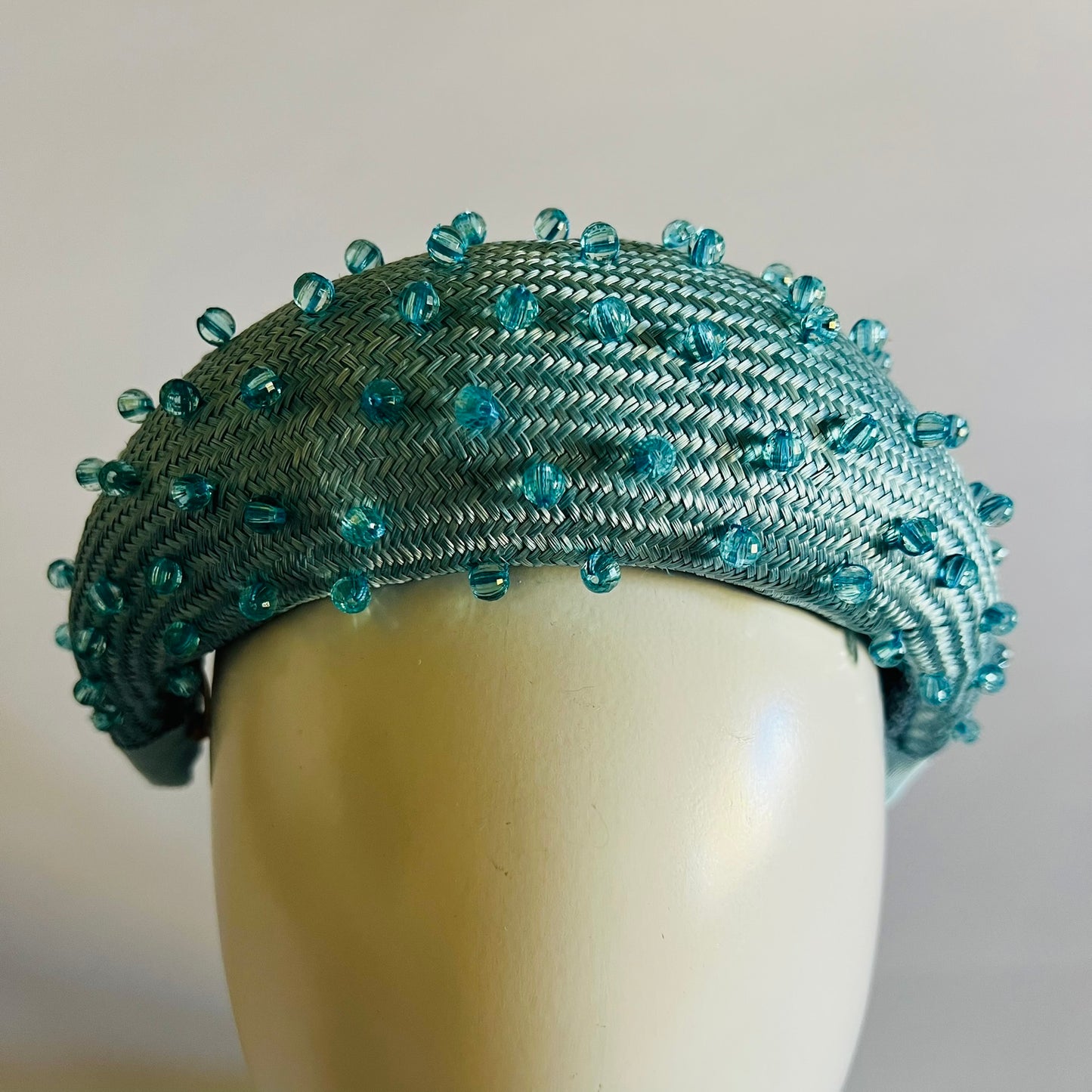 A pale blue padded headband finished with delicate bead trim. Stylish yet comfortable, it’s an easy way to elevate your look. Secured with elastic to the back of the head.