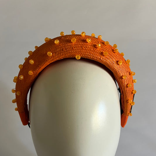 Orange padded headband finished with delicate bead trim