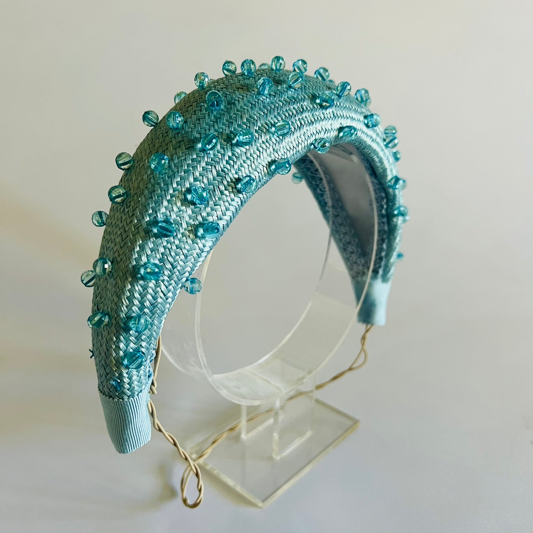  A pale blue padded headband finished with delicate bead trim. Stylish yet comfortable, it’s an easy way to elevate your look. Secured with elastic to the back of the head.